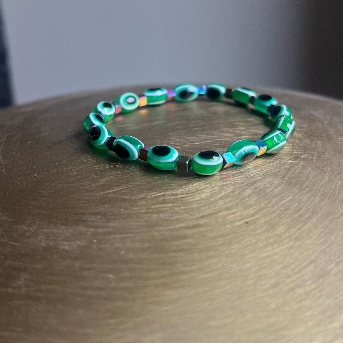 Emerald green evil eye bracelet from different angles - versatile spiritual jewelry