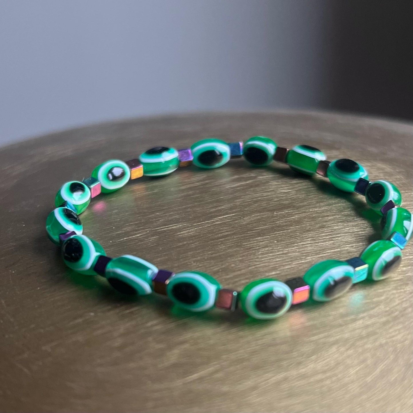 Close-up of 8mm emerald green evil eye beads with semi-precious stones - detailed spiritual jewelry