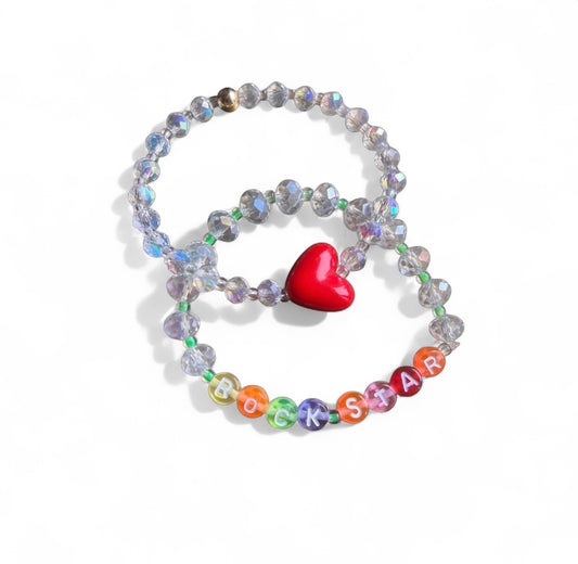 Heart of a Rockstar bracelet set displayed on white background showing gold beads and red heart charm