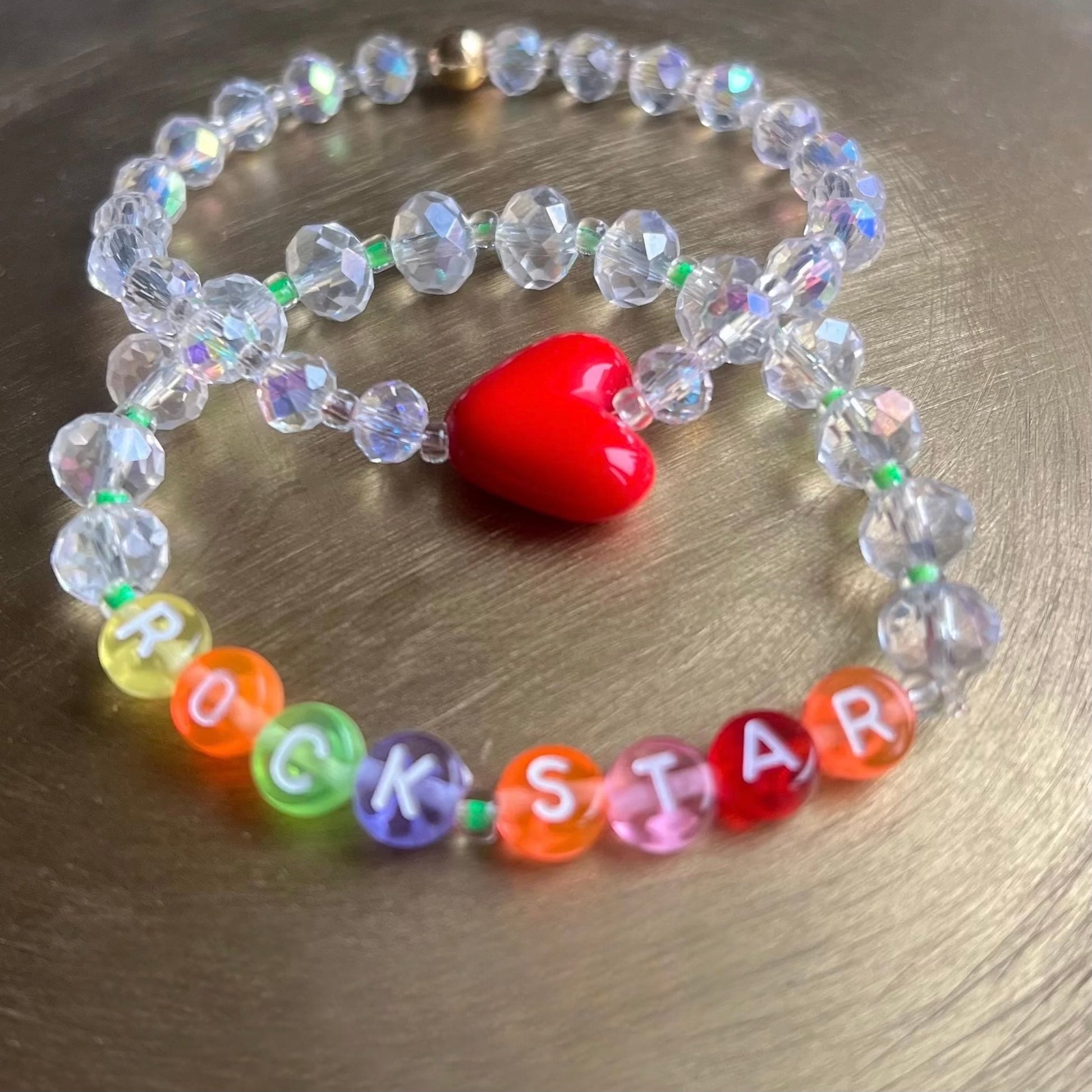 Close-up detail of Heart of a Rockstar bracelet featuring 14k gold spacer beads and clear gemstones