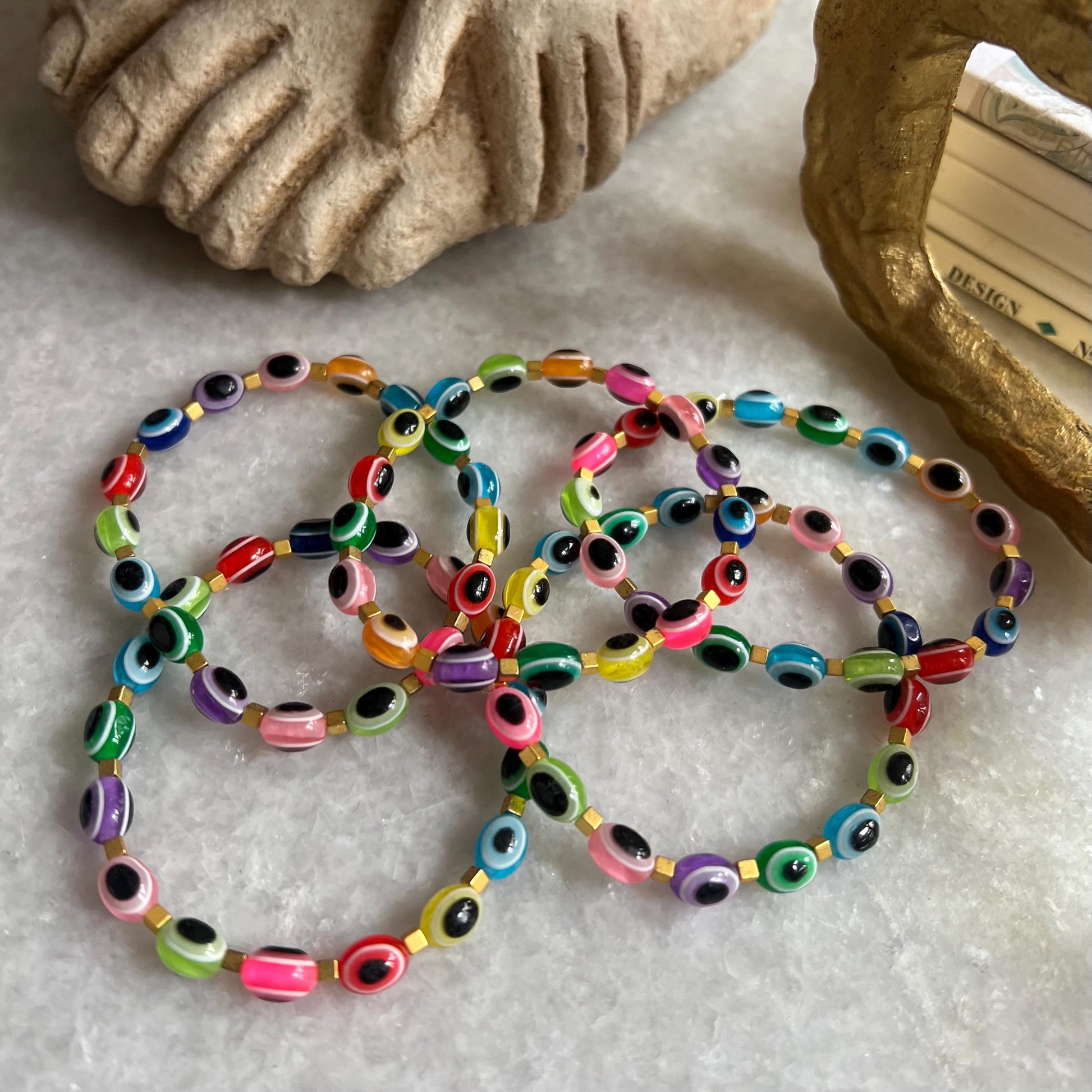Close-up of colorful evil eye charms on tutti frutti bracelet - detailed spiritual jewelry