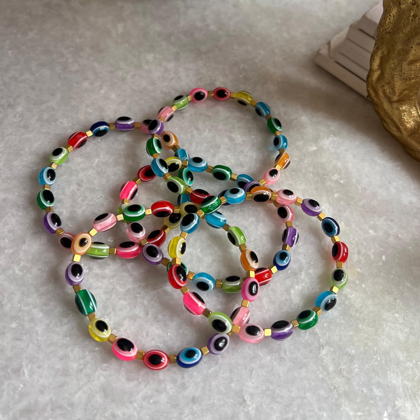 Tutti frutti evil eye bracelet flat lay - multicolor spiritual protection accessory