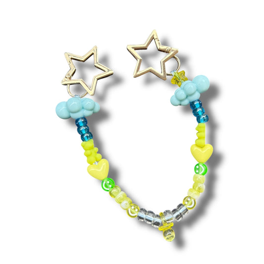 Colorful beaded bag charm with gold star clips, pastel clouds, and heart beads